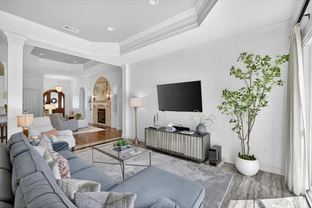 a living room with furniture fireplace and wooden floor