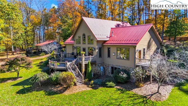 a view of a house with a yard patio and fire pit