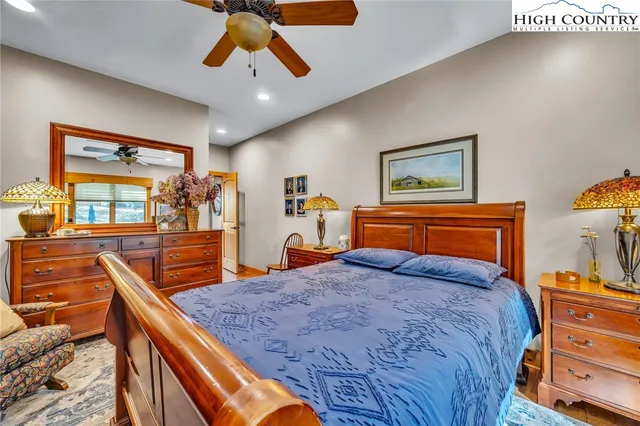 a bedroom with natural light and wooden floor