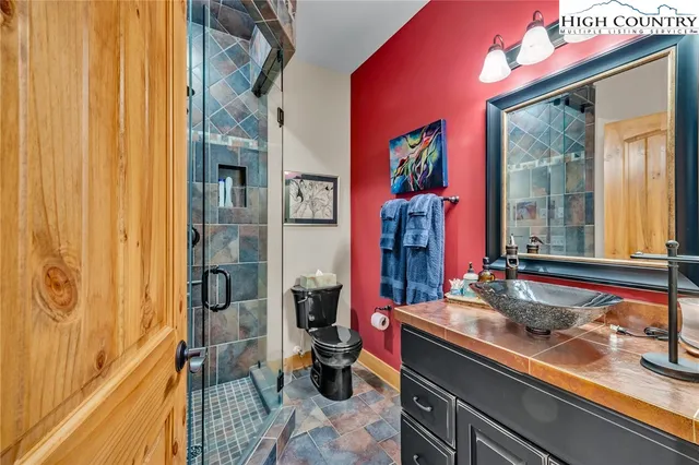a bathroom with a sink mirror and a shower