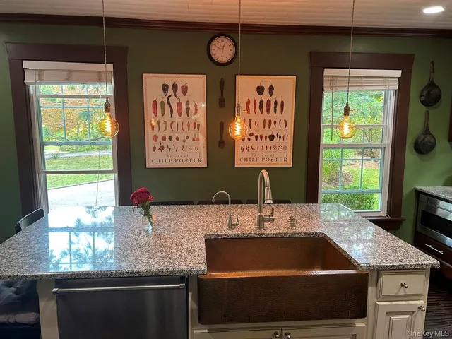 a kitchen with a sink cabinets and window