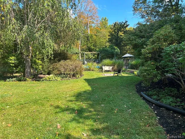 a front view of a house with a yard and potted plants