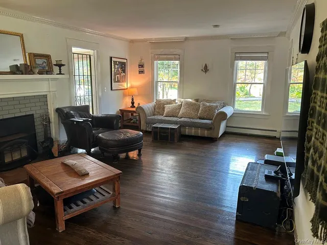 a living room with furniture a fireplace and a window