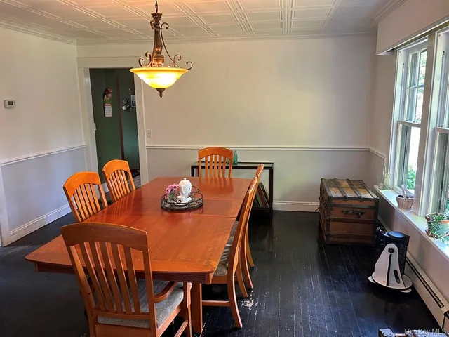 a dining room with furniture and window