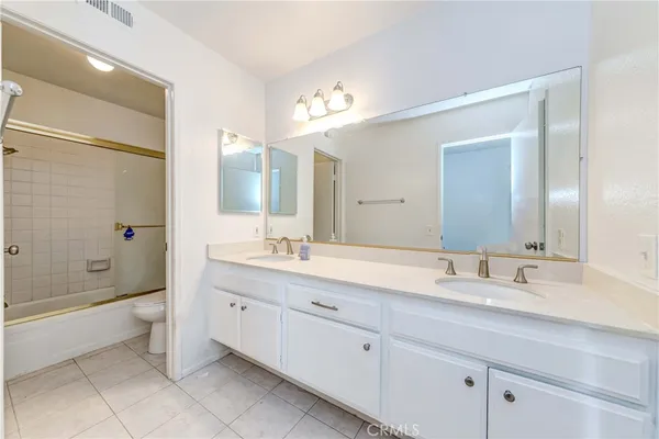 a bathroom with a double vanity sink mirror and double
