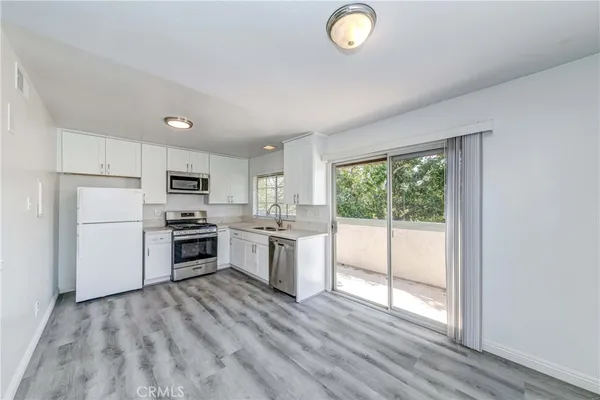a kitchen with stove cabinets and refrigerator