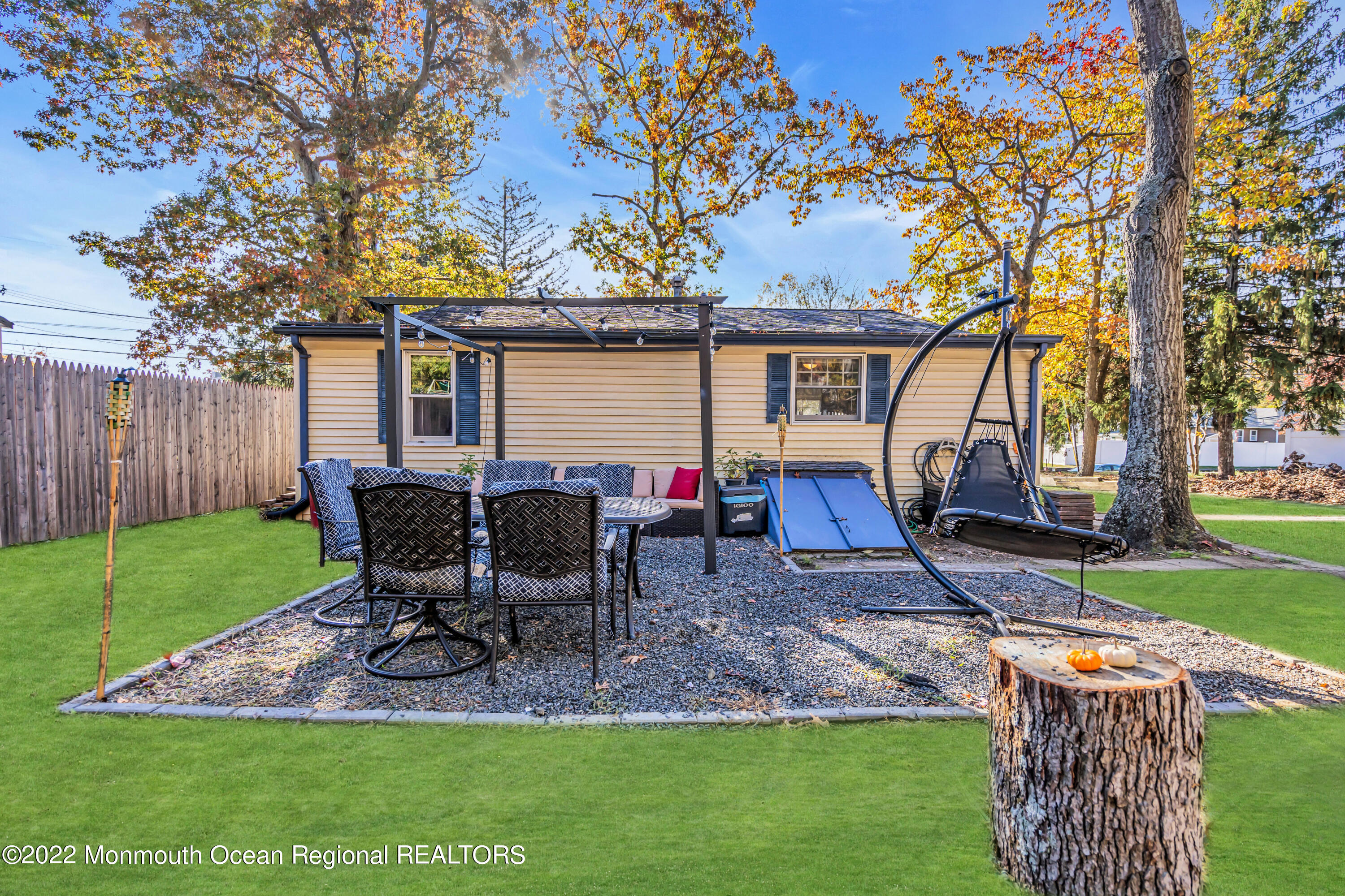 415 Shady Lane Howell, NJ 07731 - Photo 18 of 20 a view of a backyard with table and chairs and a slide