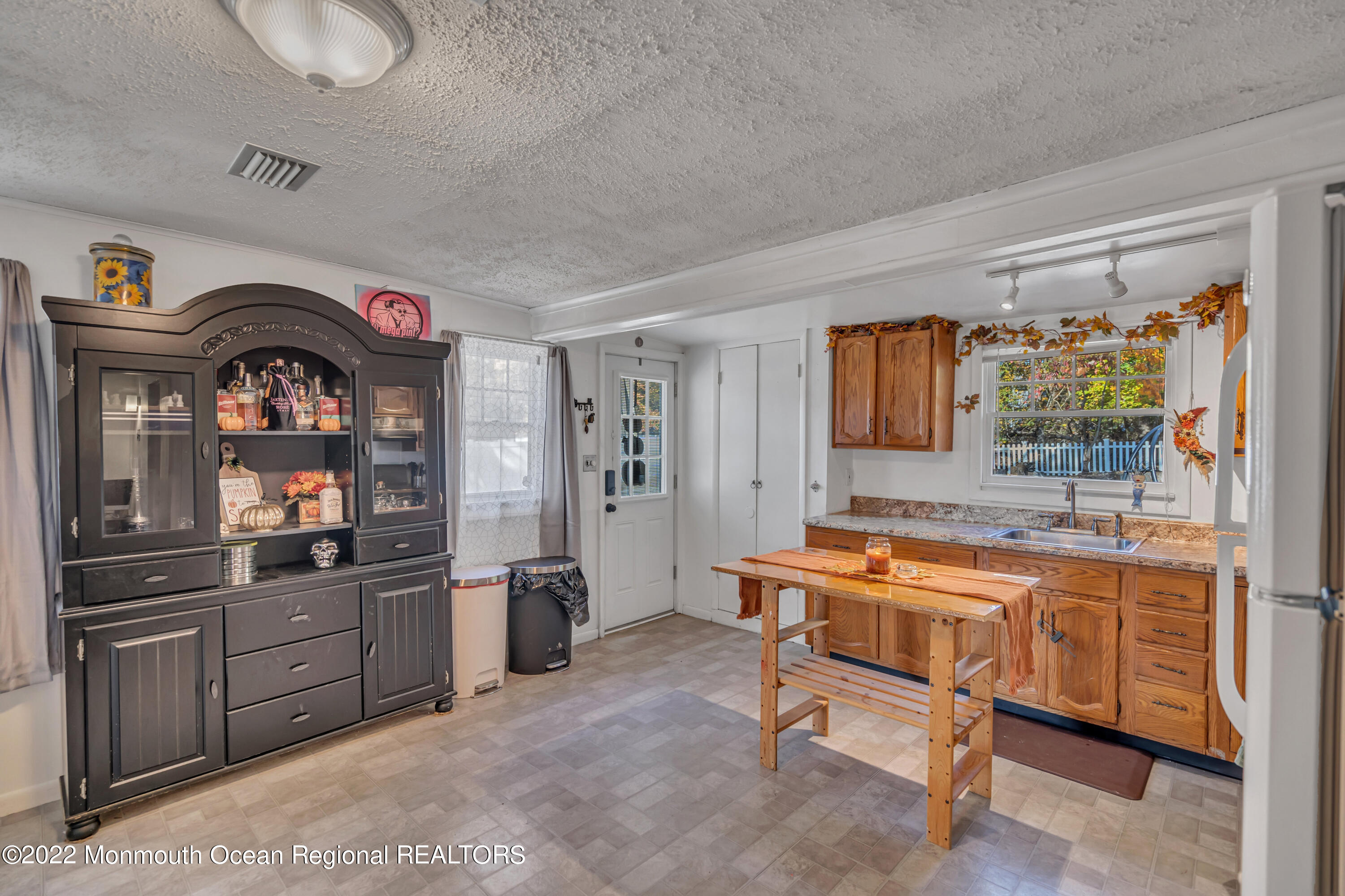 415 Shady Lane Howell, NJ 07731 - Photo 7 of 20 a living room with stainless steel appliances kitchen island granite countertop furniture and a large window