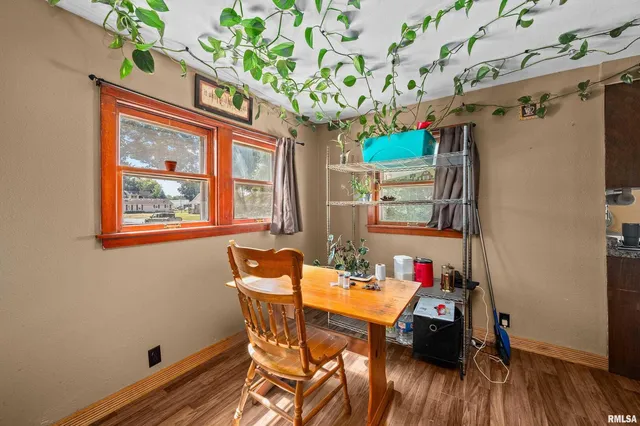 a view of a dining room with furniture a chandelier and wooden floor