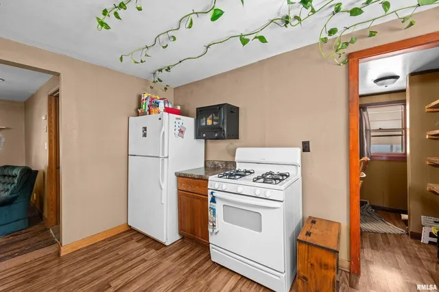 a storage room with wooden floor washer and dryer