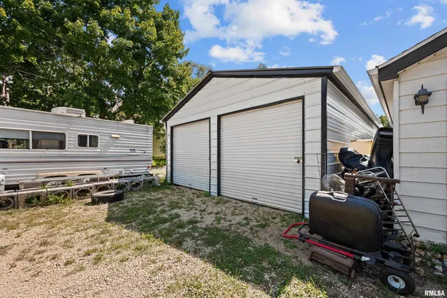 a backyard of a house with wooden floor and fence