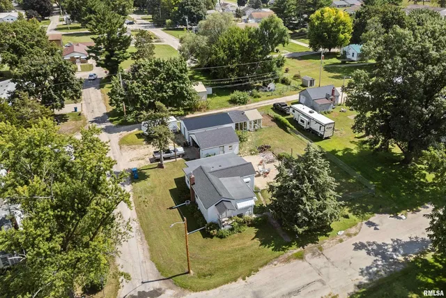 an aerial view of a house with a yard