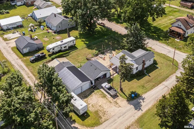 an aerial view of a house with a yard