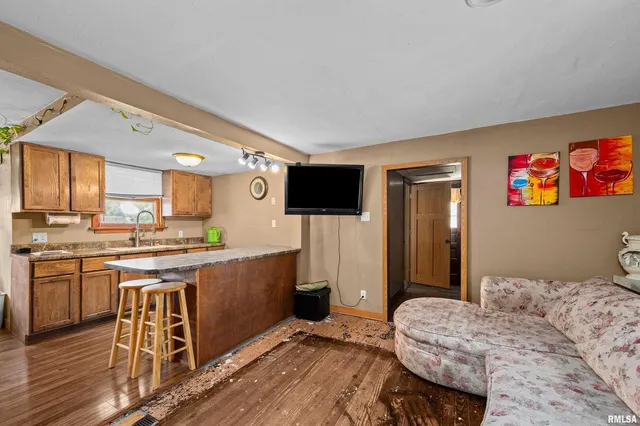 a kitchen with stainless steel appliances kitchen island granite countertop a sink and cabinets