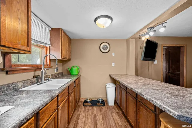 a kitchen with granite countertop counter space a sink and stainless steel appliances