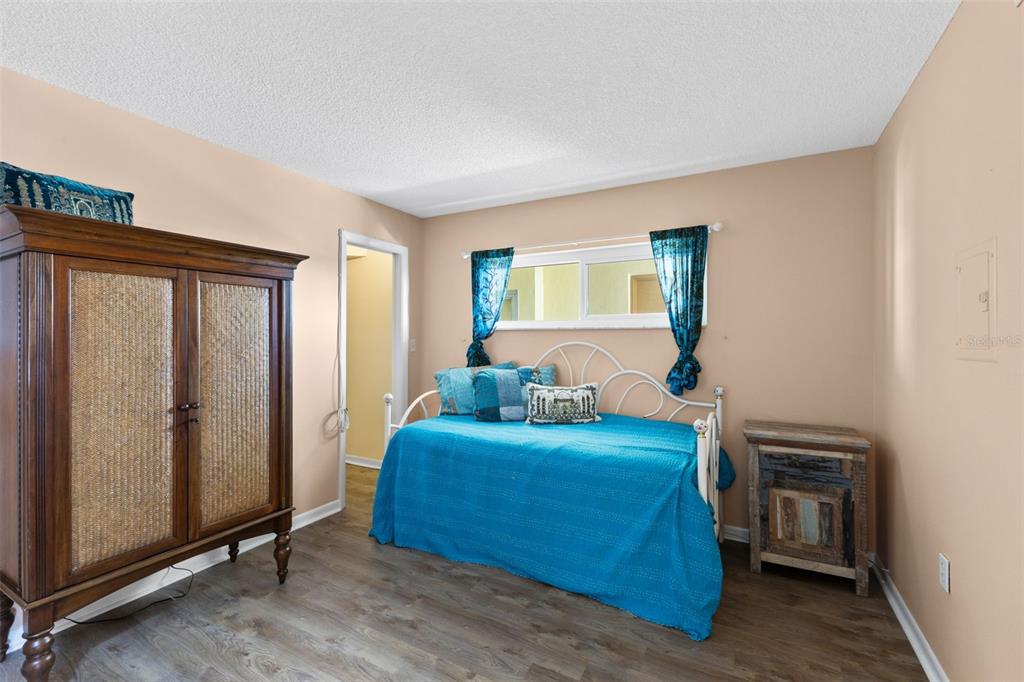 4550 Cove Circle, Unit 501 St. Petersburg, FL 33708 - Photo 20 of 44 a bedroom with a bed and a mirror