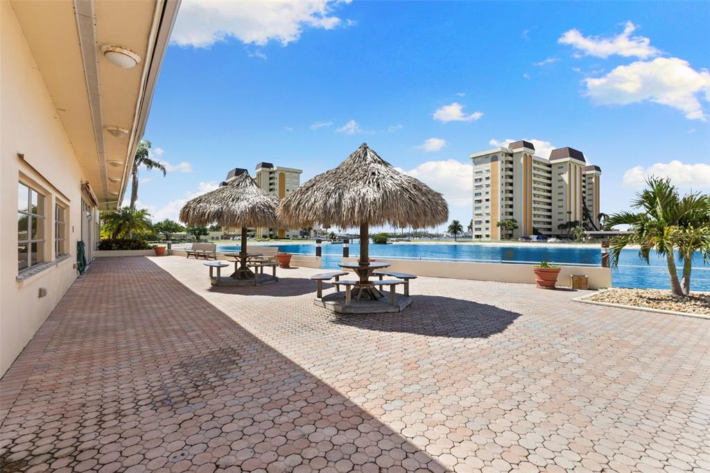4550 Cove Circle, Unit 501 St. Petersburg, FL 33708 - Photo 30 of 44 a view of a swimming pool with a terrace
