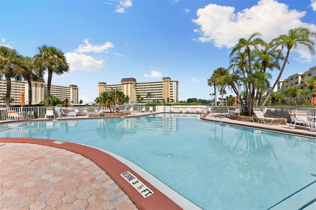 4550 Cove Circle, Unit 501 St. Petersburg, FL 33708 - Photo 32 of 44 a view of a swimming pool with a terrace