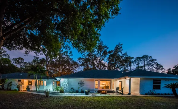 a view of house with outdoor space and garden