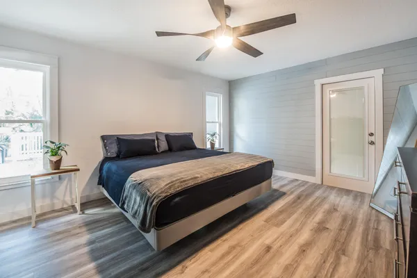 a bedroom with a large bed and a chandelier