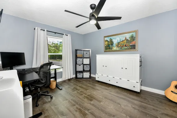 a view of a workspace with furniture and a window