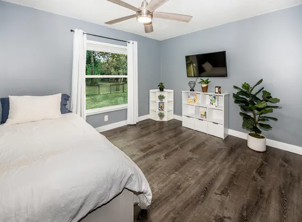 a bedroom with a bed and a flat screen tv