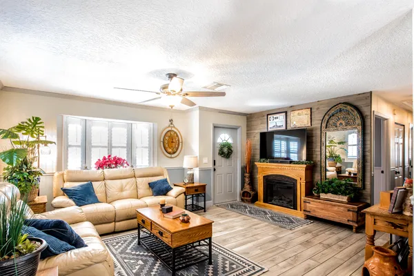 a living room with furniture a fireplace and a flat screen tv