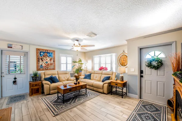 a living room with furniture a fireplace and a window