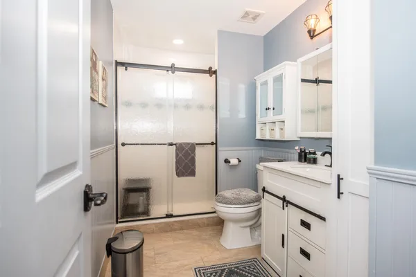 a bathroom with a sink toilet and shower