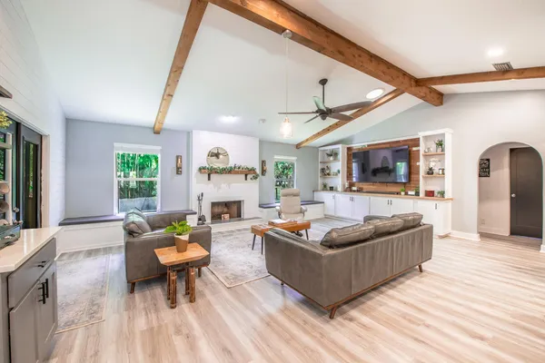 a living room with fireplace furniture and a flat screen tv