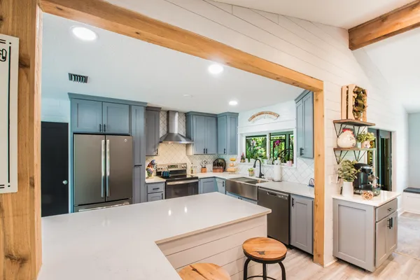 a kitchen with a refrigerator and a stove