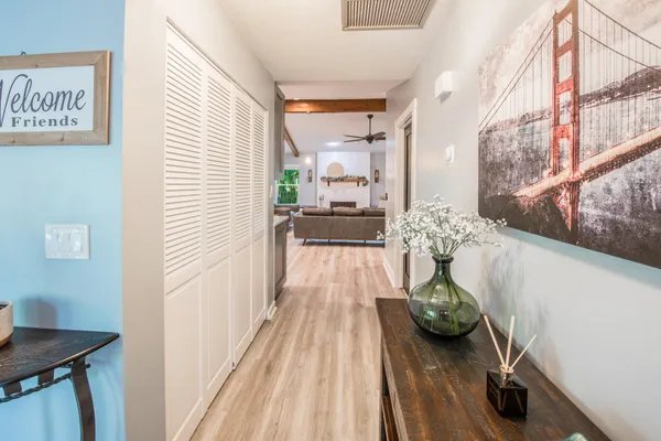 a view of a room with furniture and wooden floor
