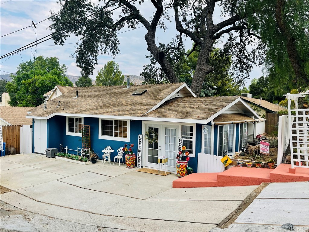 a front view of a house with dining room and wooden fence