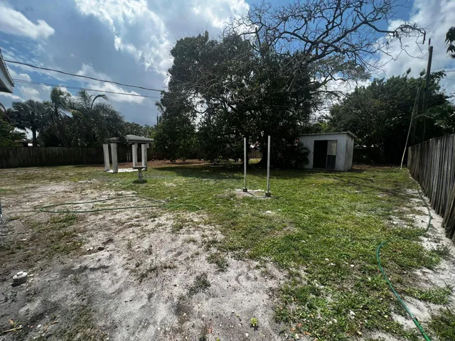 a front view of house with yard and trees