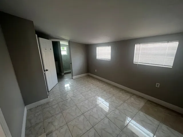 an empty room with windows and entrance