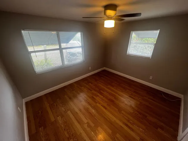 a view of empty room with fan and window