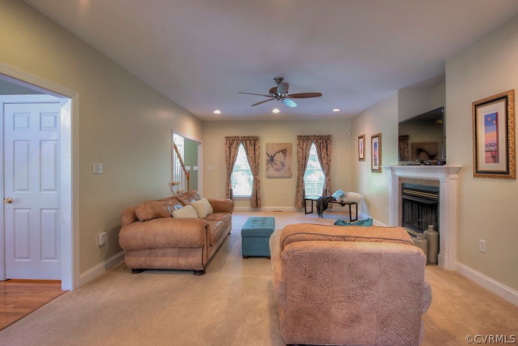 13340 Eppes Falls Road Chesterfield, VA 23838 - Photo 12 of 50 a living room with furniture a fireplace and a flat screen tv