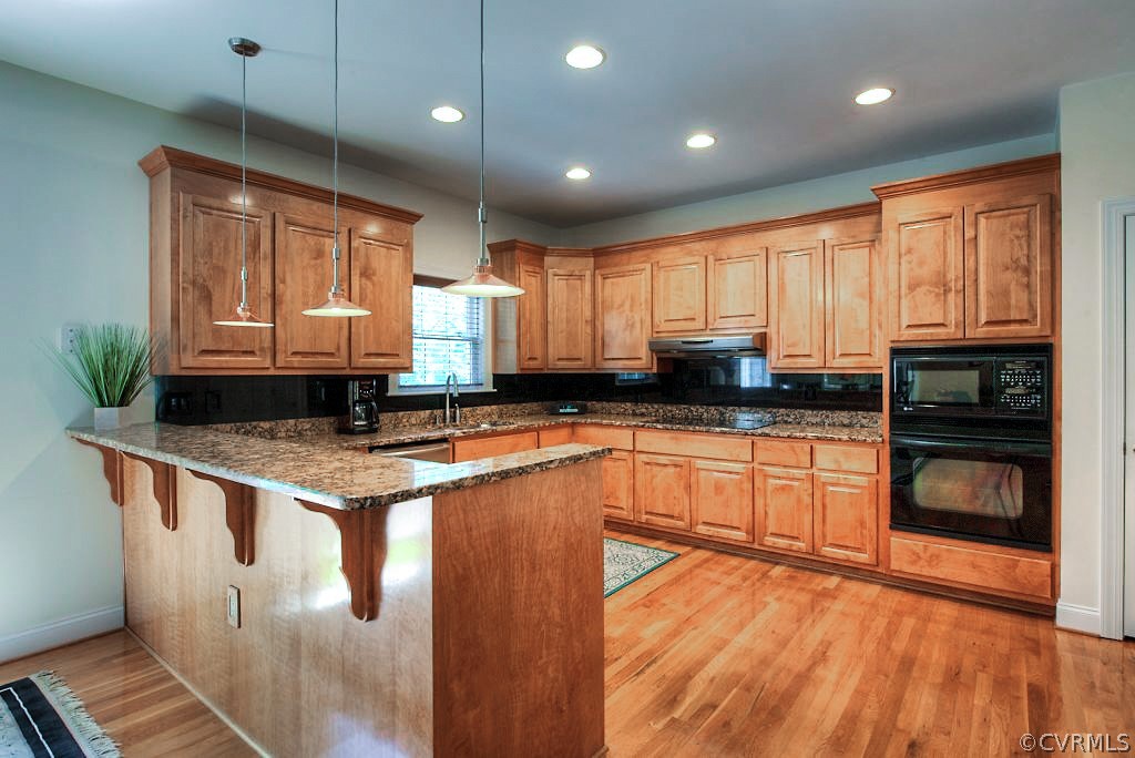13340 Eppes Falls Road Chesterfield, VA 23838 - Photo 17 of 50 a kitchen with a stove a sink and a microwave