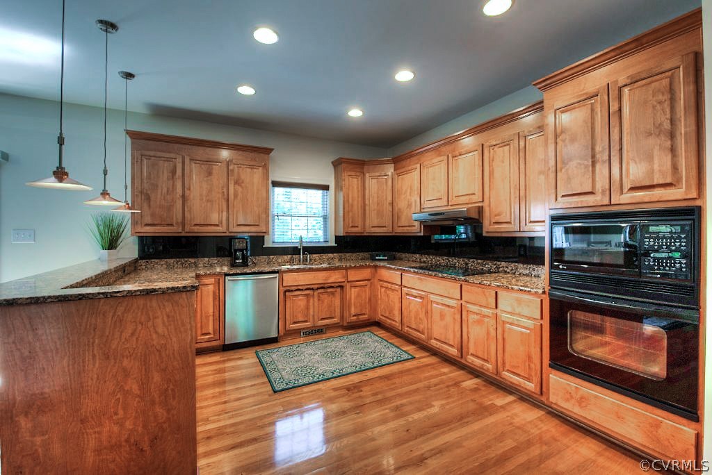 13340 Eppes Falls Road Chesterfield, VA 23838 - Photo 18 of 50 a kitchen with granite countertop wooden floors stainless steel appliances a sink and a window