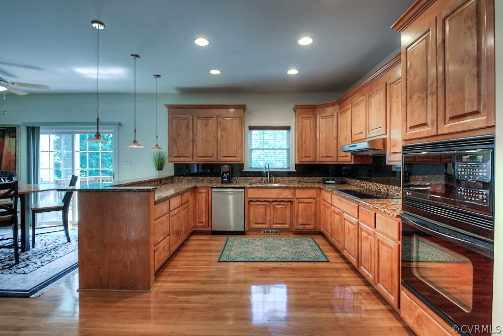 13340 Eppes Falls Road Chesterfield, VA 23838 - Photo 19 of 50 a large kitchen with granite countertop a stove a sink and dishwasher wooden cabinets with granite countertops