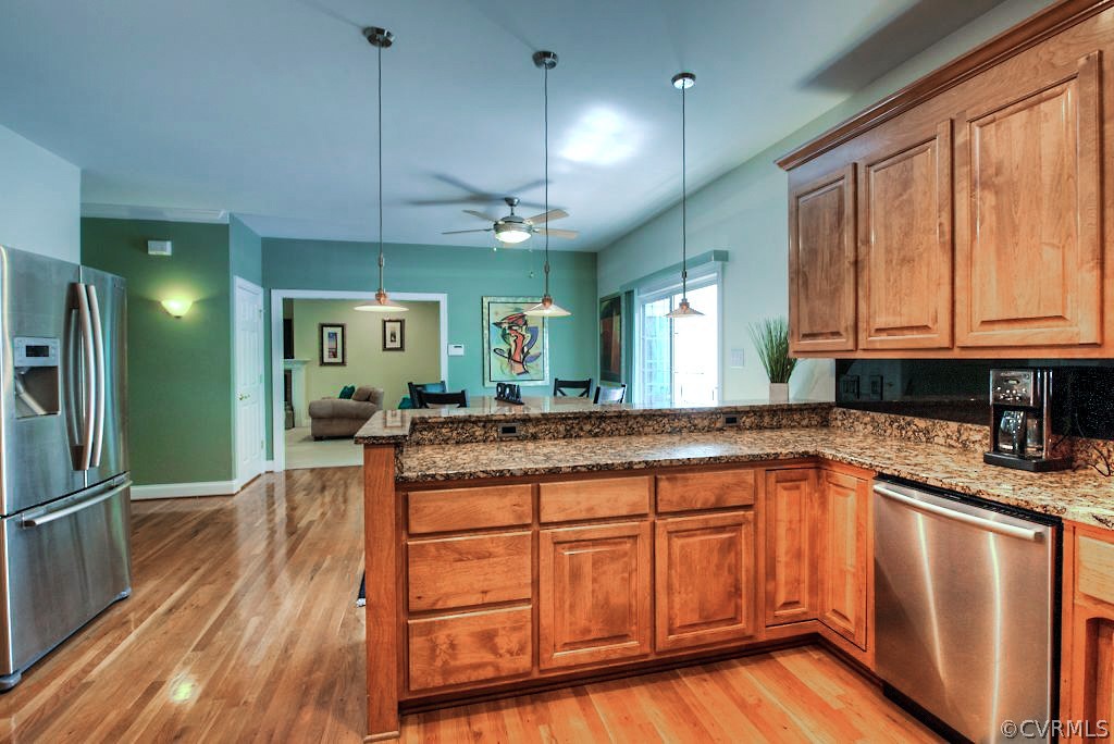 13340 Eppes Falls Road Chesterfield, VA 23838 - Photo 21 of 50 a kitchen with stainless steel appliances granite countertop a sink a stove cabinets and wooden floor