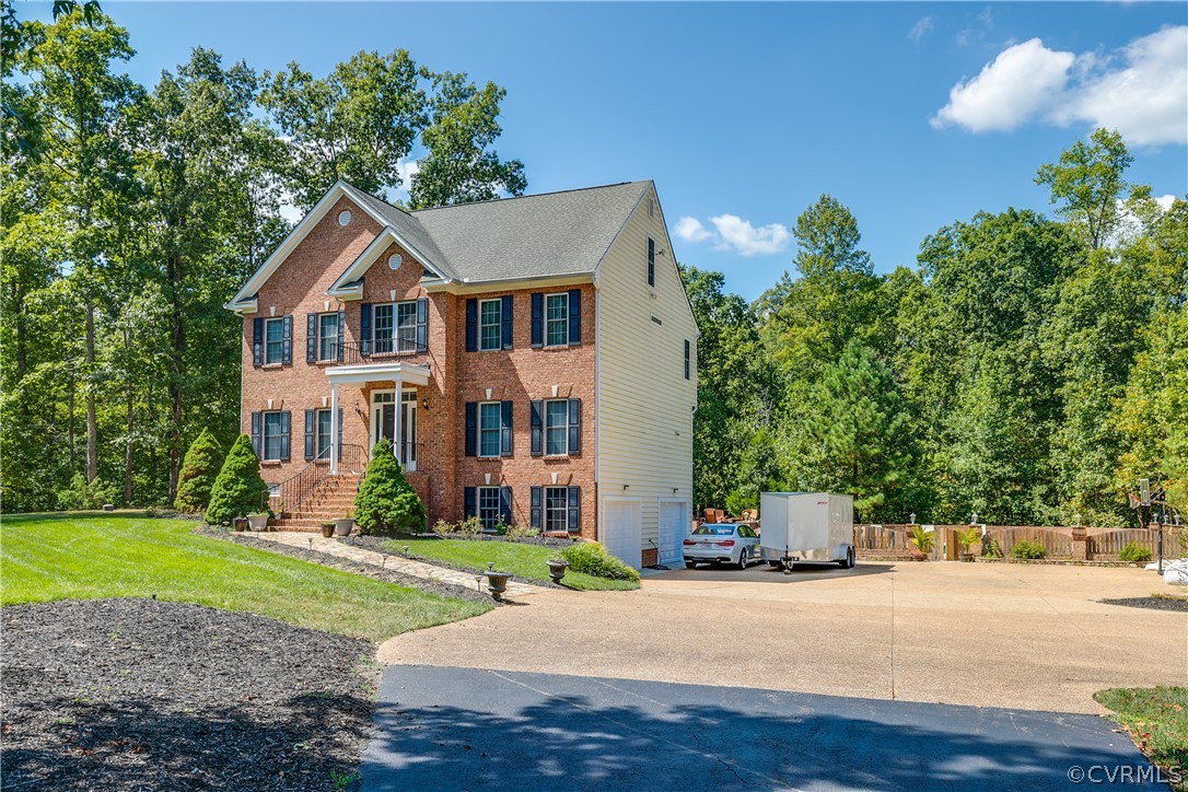 13340 Eppes Falls Road Chesterfield, VA 23838 - Photo 3 of 50 a front view of a house with a yard and a garden