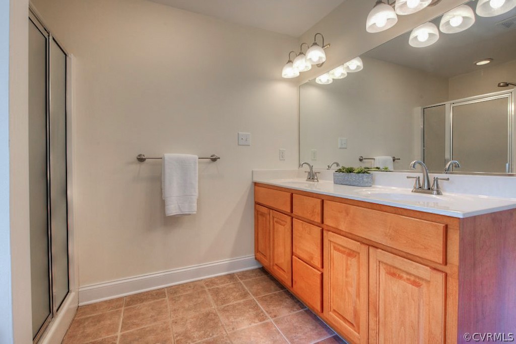 13340 Eppes Falls Road Chesterfield, VA 23838 - Photo 31 of 50 a bathroom with a double vanity sink and a mirror