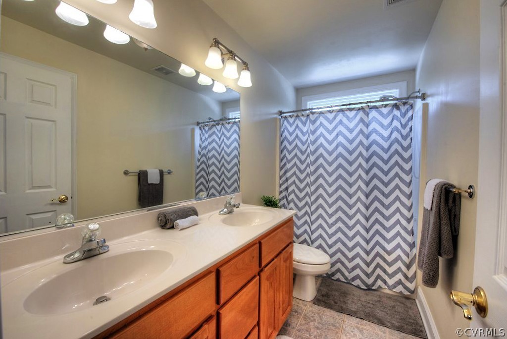 13340 Eppes Falls Road Chesterfield, VA 23838 - Photo 35 of 50 a bathroom with a sink a toilet and mirror