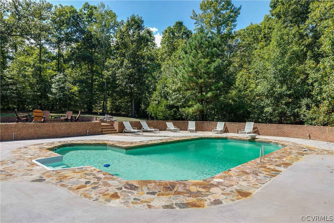 13340 Eppes Falls Road Chesterfield, VA 23838 - Photo 4 of 50 a view of a swimming pool with a yard
