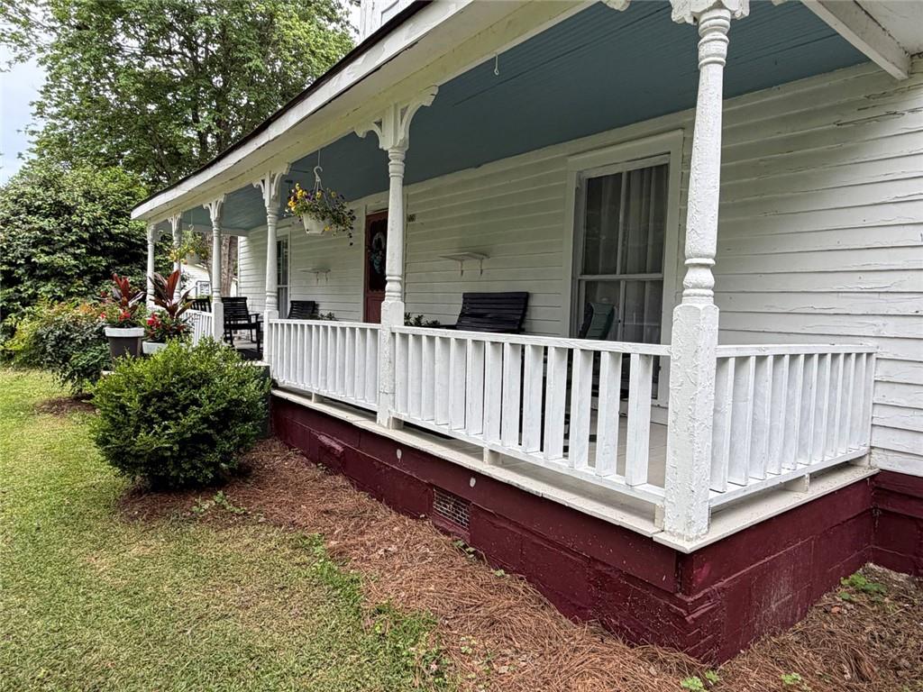209 Old Perry Road Marshallville, GA 31057 - Photo 22 of 40 a view of a house with wooden deck and furniture