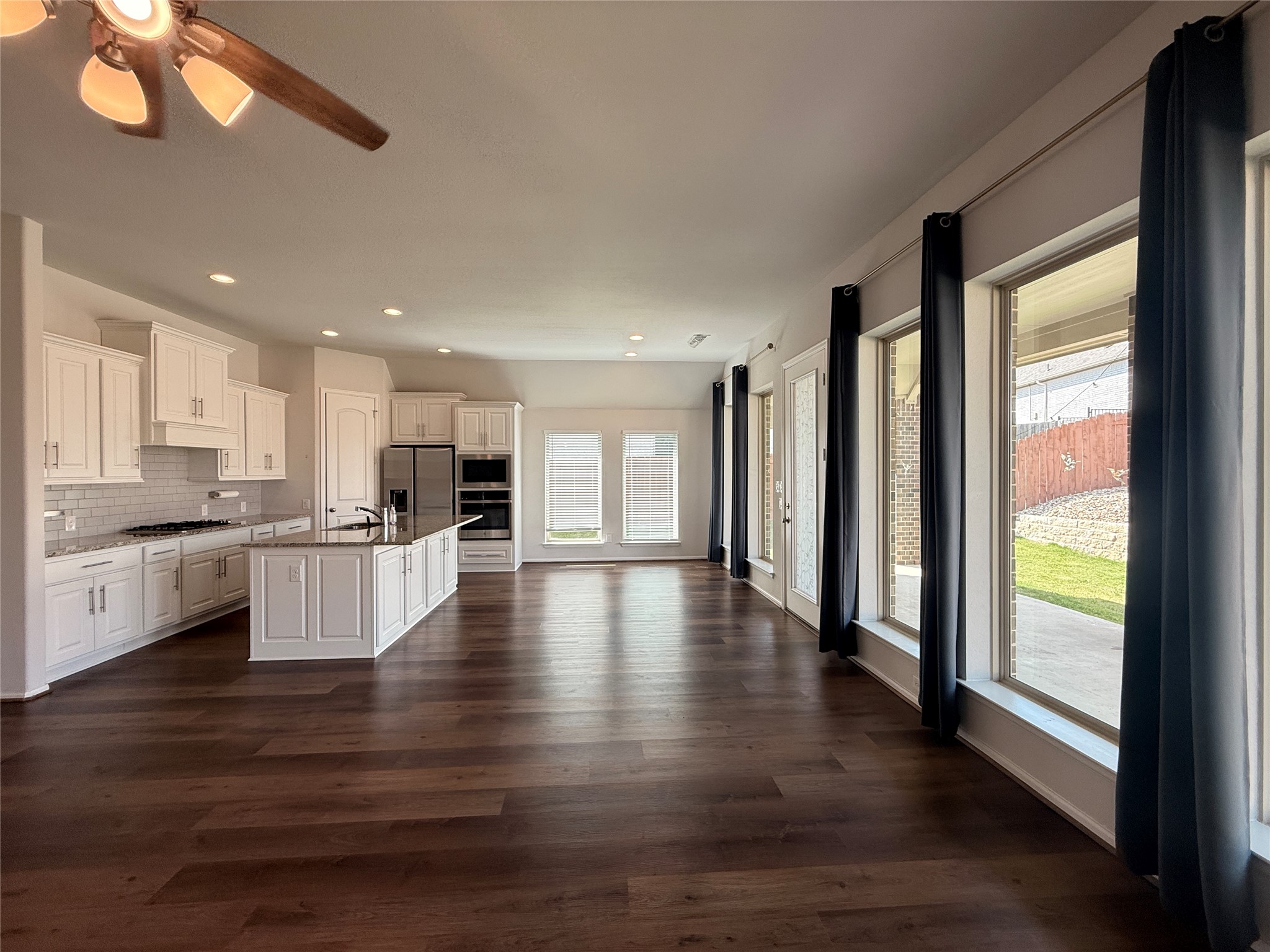 156 Santa Maria Street Georgetown, TX 78628 - Photo 10 of 39 a view of kitchen with kitchen island wooden floors and stainless steel appliances