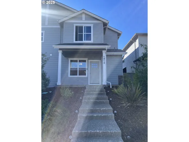 a view of a brick house with large windows