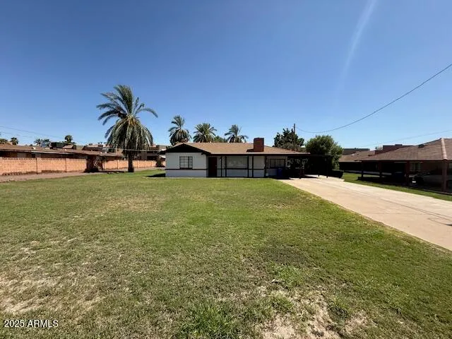 a view of a swimming pool with an outdoor seating and a yard