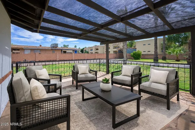 a roof deck with a table and chairs